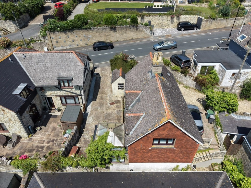 Lot: 88 - TWO-BEDROOM COTTAGE FOR IMPROVEMENT - A Reverse View of the Cottage
